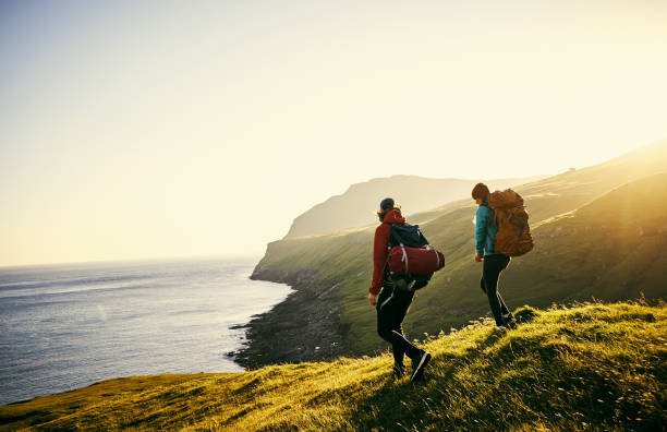 Shot of a young couple hiking through the mountains