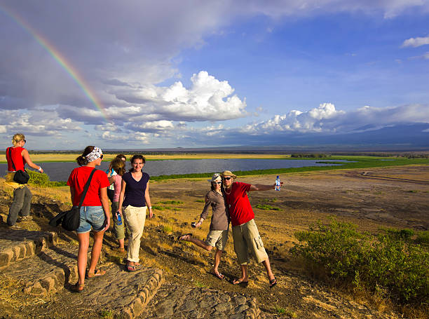 "Tourists  on amazing after rain, evening light at Amboseli NP,  Kenya,  East Africa."